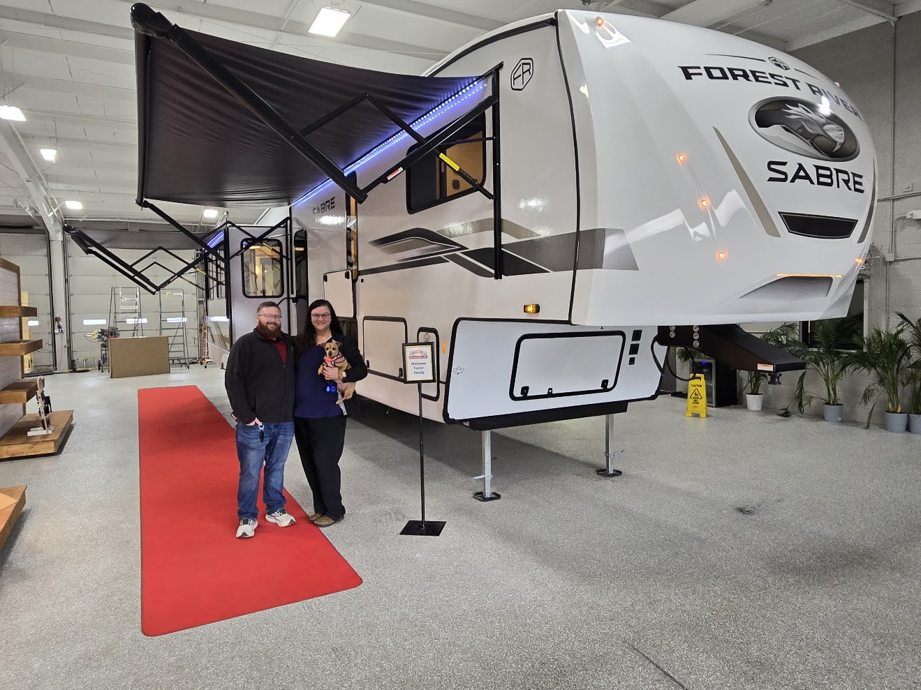 James and Mallory with Willow in front of our Sabre 5th wheel